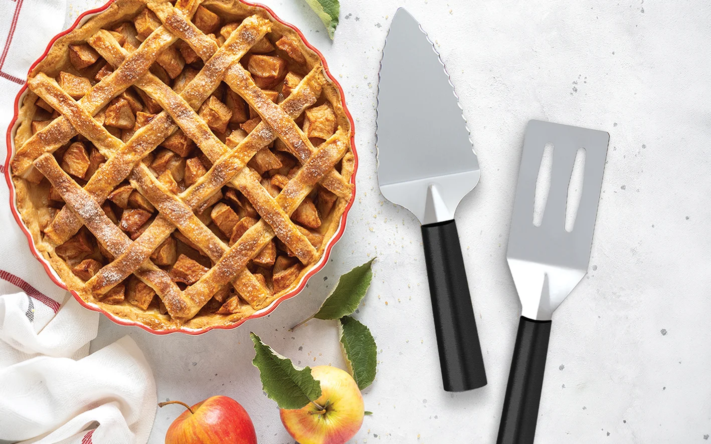 Rada Cutlery serrated pie server and spatula beside a fresh apple pie